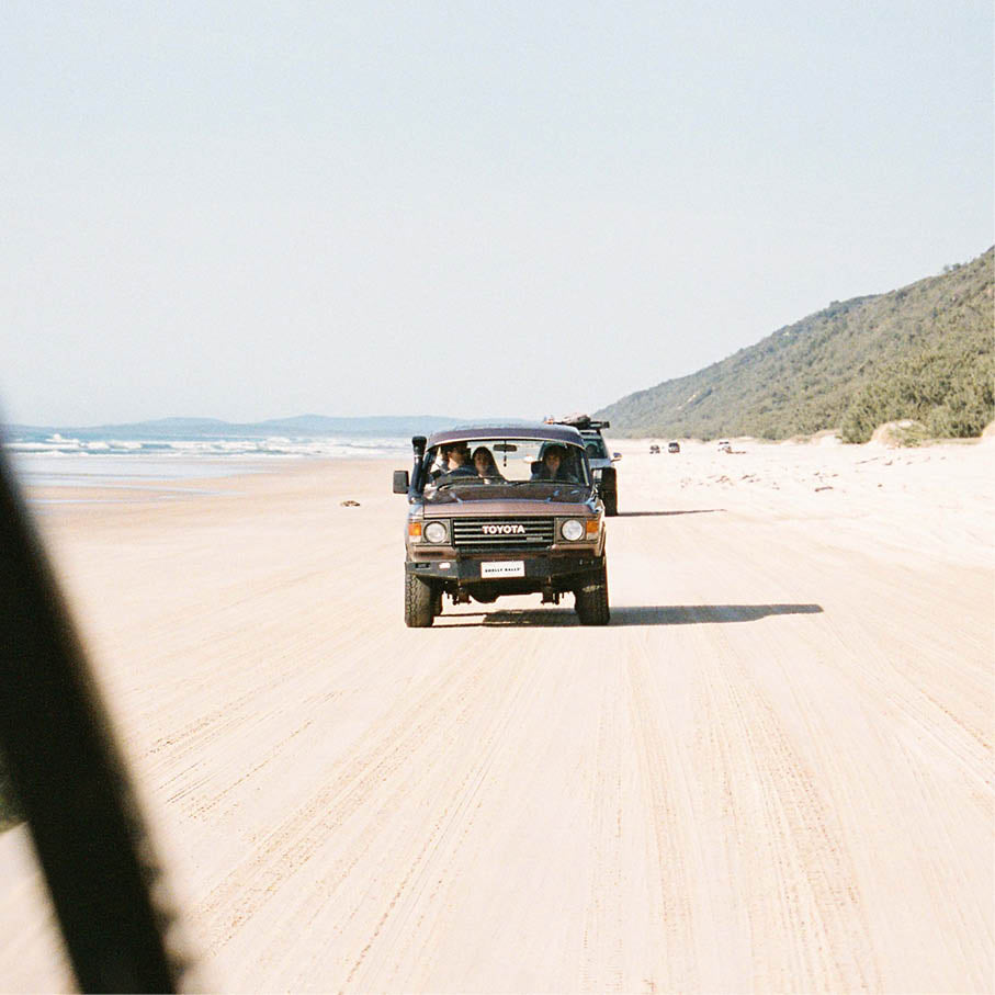 Car driving along double island beach with a reusable air fresheners